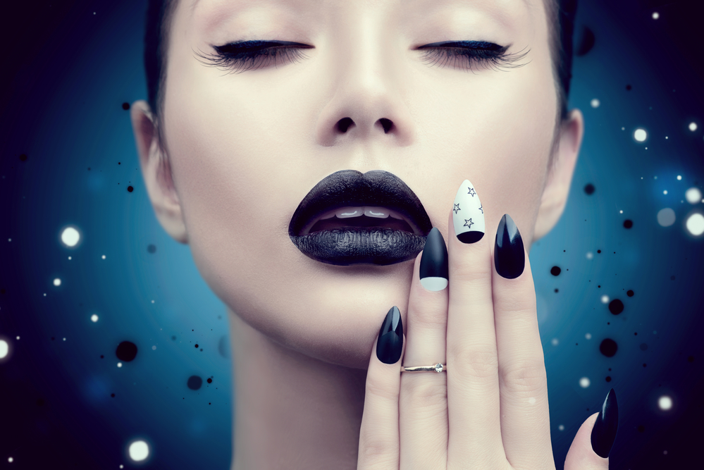 Fashion model girl with trendy gothic black makeup
