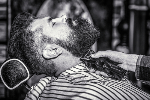 Barber,Works,With,A,Beard,Clipper.,Hipster,Client,Getting,Haircut.