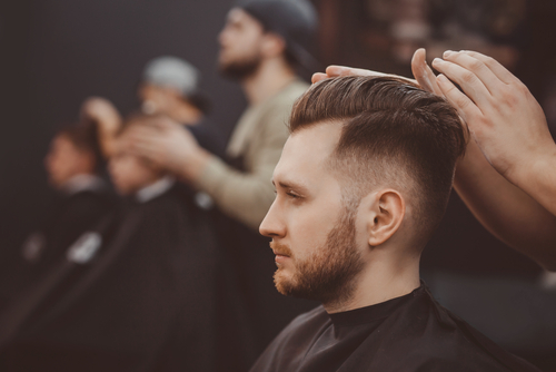 Barber,Shop.,Man,In,Barber's,Chair,,Hairdresser,Styling,His,Hair