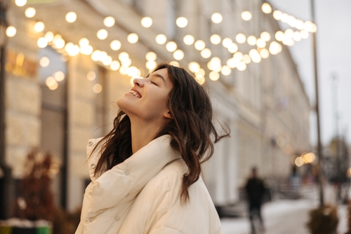 Positive,Young,Caucasian,Woman,Stands,Outdoor,With,Closed,Eyes,Smiling