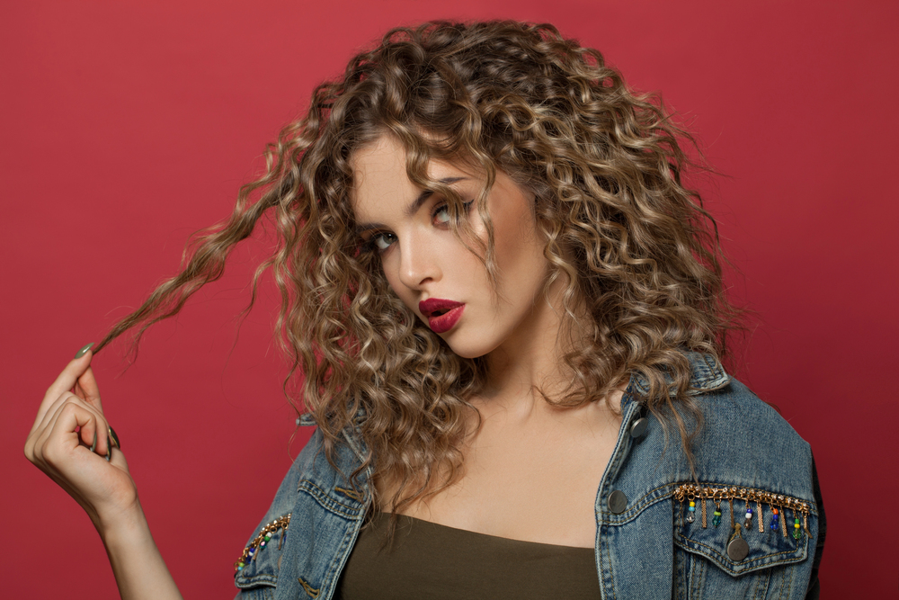 Woman with healthy curly hair showing defined, frizz-free curls at Anna's Salon Elite in Aliquippa, PA.