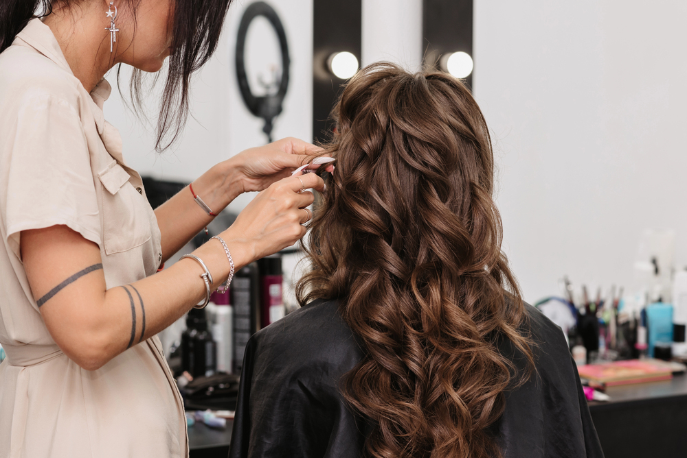 Long brown hair styled in soft curls, illustrating special occasion hair styling.